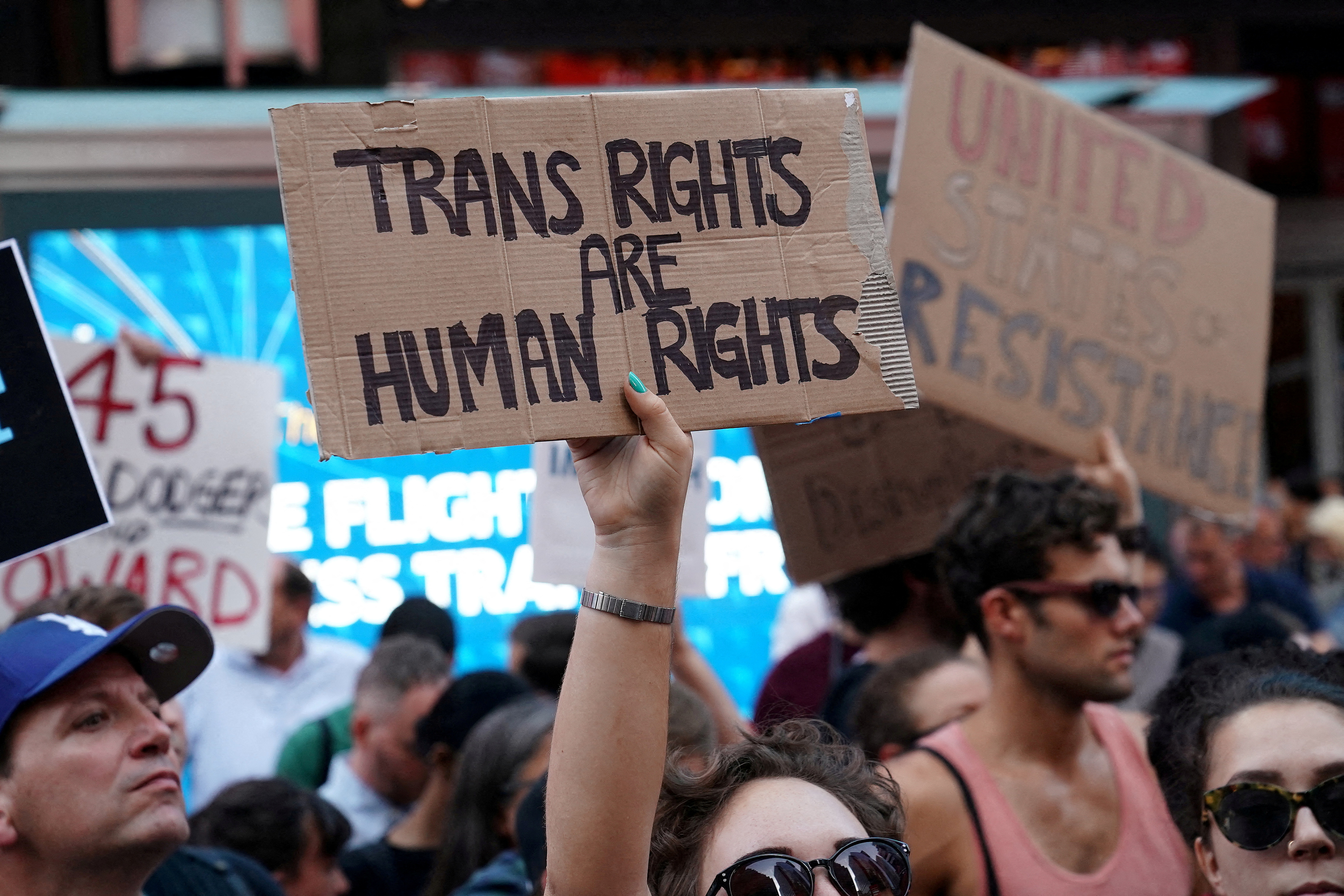 People protest U.S. President Donald Trump's announcement that he plans to reinstate a ban on transgender individuals from serving in any capacity in the U.S. military, in Times Square, in New York City